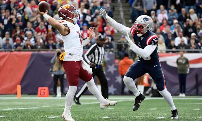 Washington Commanders quarterback Sam Howell (left) throws a pass against the New England Patriots (right).